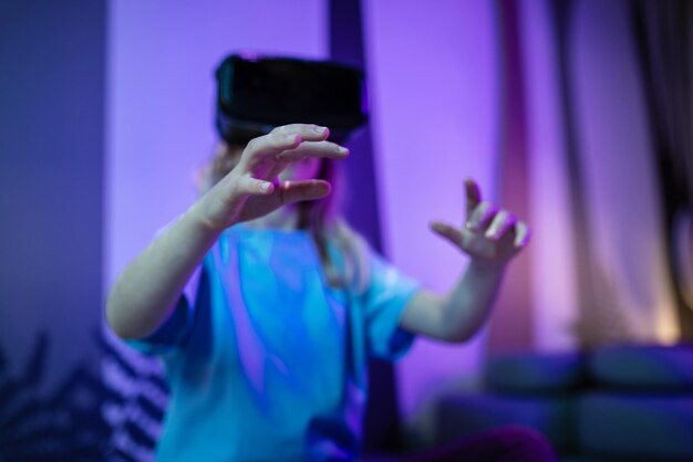 Niña que usa nuevas tecnologías divirtiéndose con gafas de realidad virtual en la sala virtual de