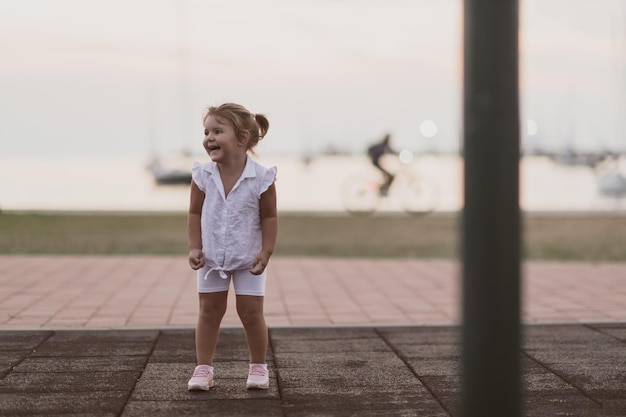 Una niña con ropa de verano moderna jugando en el parque en el enfoque selectivo de verano