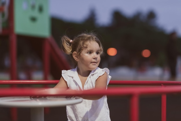 Una niña con ropa de verano moderna jugando en el parque en el enfoque selectivo de verano