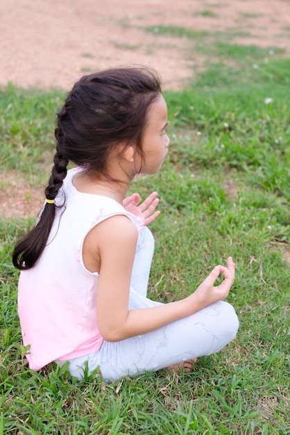 Foto niña sentada en el campo