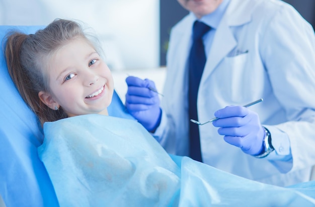 Niña sentada en la oficina de dentistas