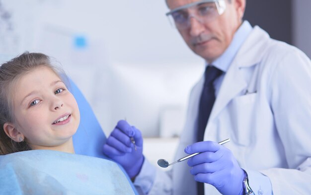 Niña sentada en la oficina de dentistas