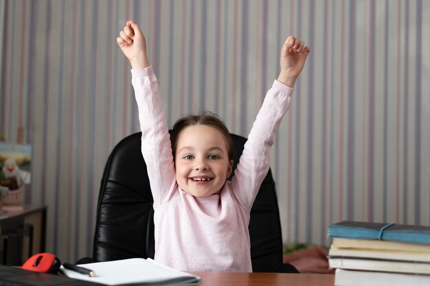 Niña sentada en su casa en el escritorio.