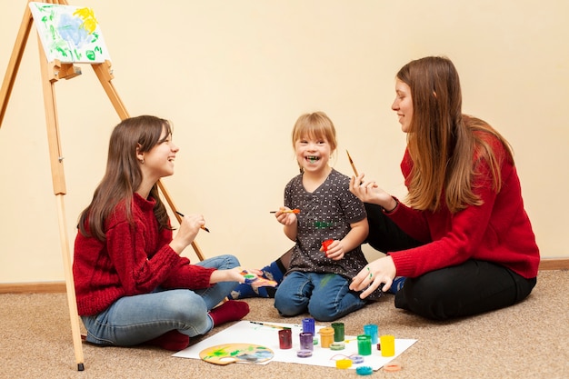 Niña con síndrome de down y pintura de mujer