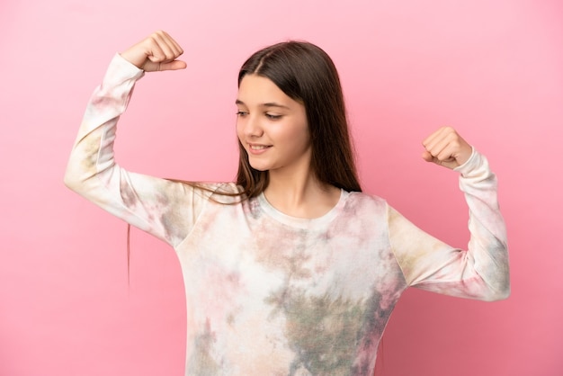 Niña sobre fondo rosa aislado haciendo gesto fuerte