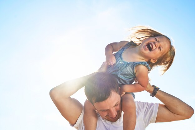 niña sobre los hombros de papá.