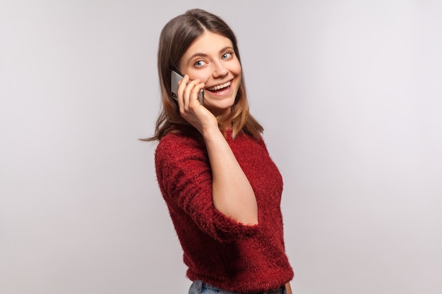 niña sosteniendo el teléfono y hablando con el móvil