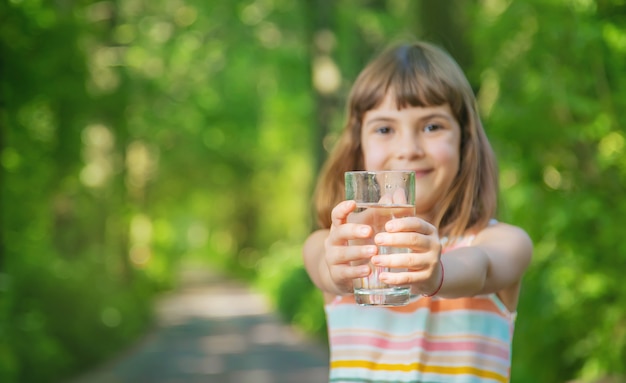 Niña sosteniendo un vaso de agua