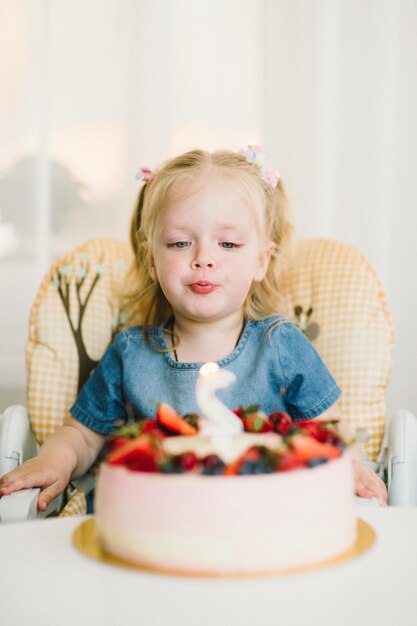 Niña en su cumpleaños acepta felicitaciones y come pastel