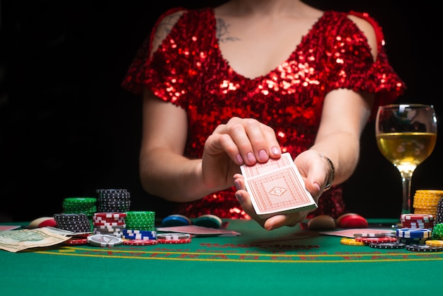 Una niña en un vestido rojo de noche juega en un casino
