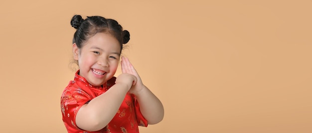 Niñas asiáticas lindas sonrientes en vestido tradicional chino rojo. Concepto de feliz año nuevo chino.