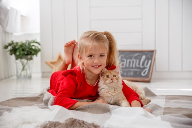 niñita con gatito tendido en el suelo del concepto de casa de familia humana y mascota