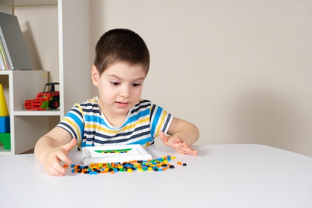 Un niño de 4 años juega con un mosaico.