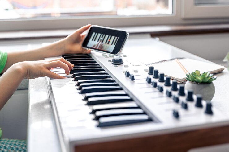 Foto el niño aprende a tocar el piano con una lección de música en línea para teléfonos inteligentes