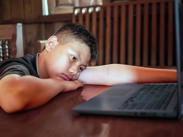 Niño asiático con cabello corto sentado molesto emoción triste y cara triste depresión concepto de niños