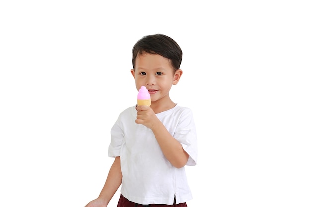 Niño asiático con helado de juguete sobre fondo blanco.