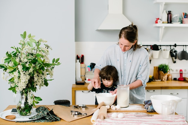 Niño ayudando a su madre a hornear en la cocina