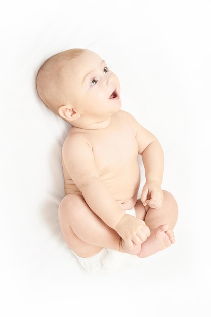 Niño bonito Acostado en casa Fondo blanco Expresión feliz Retrato de niño masculino Cuidado de la madre Usar pañal Banner vertical humano sensible divertido con espacio de copia Para la historia