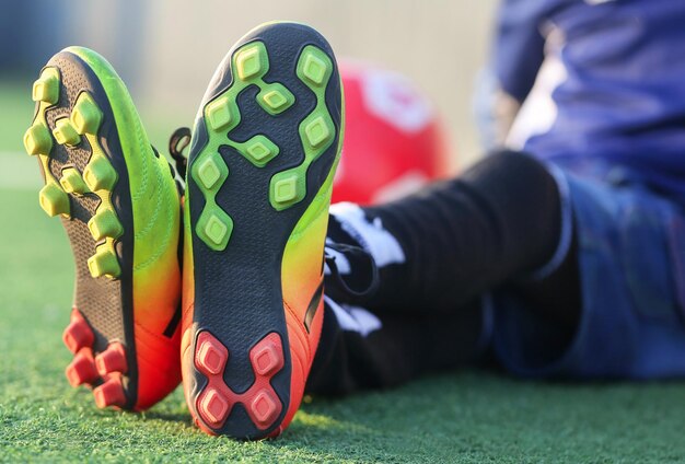 Niño con botas de fútbol entrenamiento al aire libre