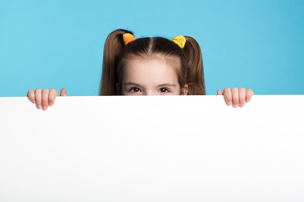 Niño de cabello oscuro con tablero blanco