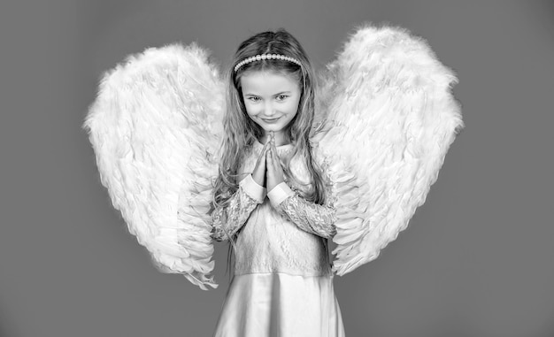 Niño con cara de ángel niña linda posando con alas de ángel hermosa niña ángel de pie