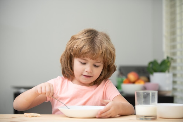 Niño comiendo alimentos saludables lindo niño comiendo sopa para el almuerzo