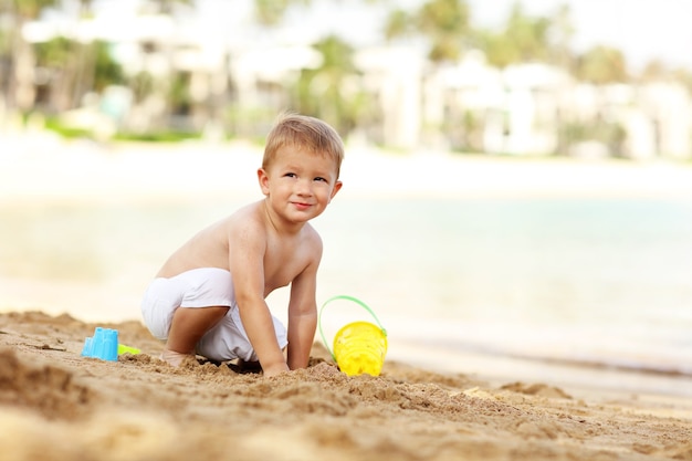 Un niño de dos años de vacaciones en la playa.
