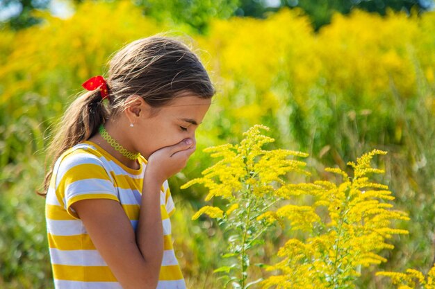 Un niño es alérgico a la ambrosia que florece en el parque enfoque selectivo