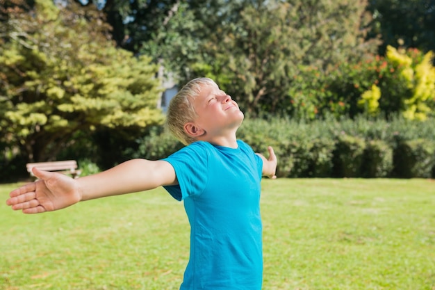 Niño estirando los brazos y disfrutando del sol