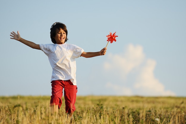 Niño feliz corriendo en el hermoso campo