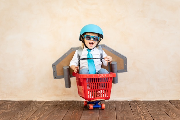 Niño gracioso con jetpack de papel