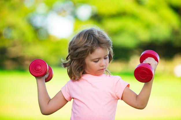 Niño haciendo ejercicio en el parque niño activo estilo de vida saludable deporte niño con fuertes músculos bíceps exercisin
