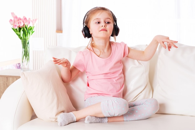 Niño haciendo música en el sofá