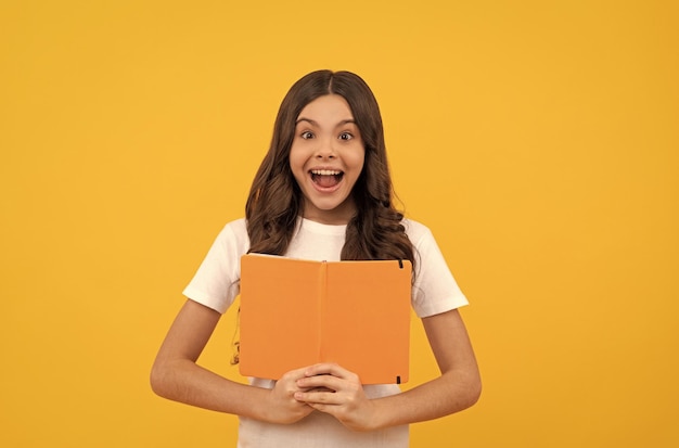 Niño inspirado estudiante prepararse para el examen colegiala hacer la tarea literatura educativa alumno sorprendido sostener enciclopedia regreso a la escuela educación niño sostener libro de lectura chica adolescente con libro