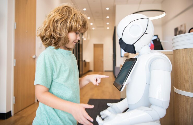 Foto el niño interactúa con la comunicación de inteligencia artificial robot