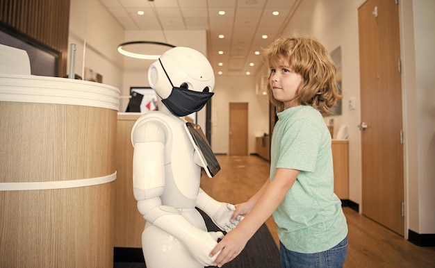 Foto el niño interactúa con el robot como comunicación tecnológica innovadora