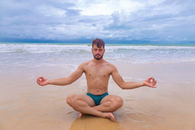 niño joven, meditar, en la playa