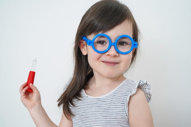 El niño juega a un médico. La niña se puso gafas.