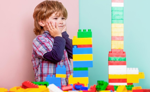 Niño jugando con coloridos bloques de juguete Juguetes educativos para niños pequeños Niño jugando con un montón de coloridos bloques de plástico constructor