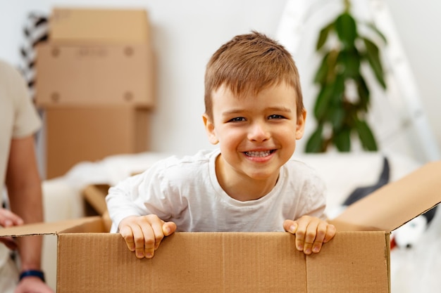 Niño jugando dentro de una caja de mudanza en un día de mudanza