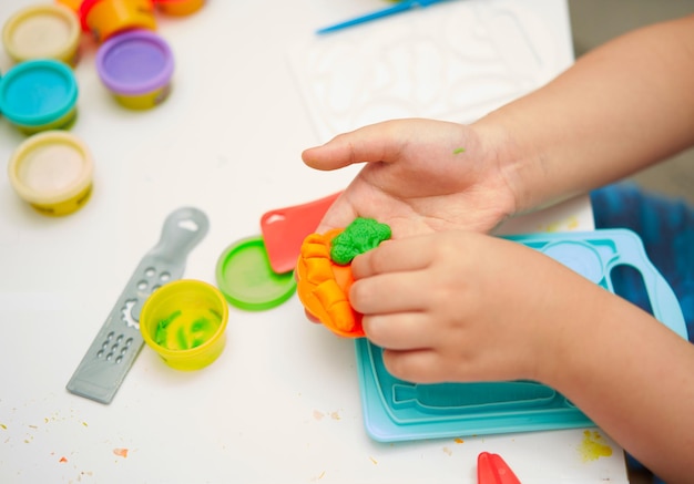 Niño jugar juguete de arcilla con aprendizaje