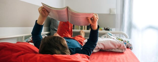 niño leyendo en su cama