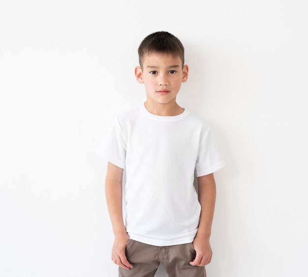 Niño lindo con camiseta blanca en blanco