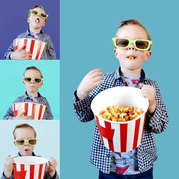 Un niño lindo y divertido, un niño de un año de edad, con una camiseta roja, sosteniendo un cubo para palomitas de maíz.