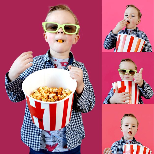 Un niño lindo y divertido, un niño de un año de edad, con una camiseta roja, sosteniendo un cubo para palomitas de maíz.