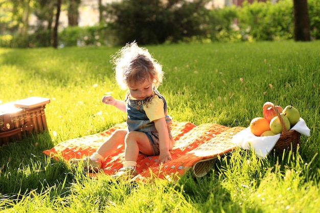 Niño lindo haciendo un picnic en el parque