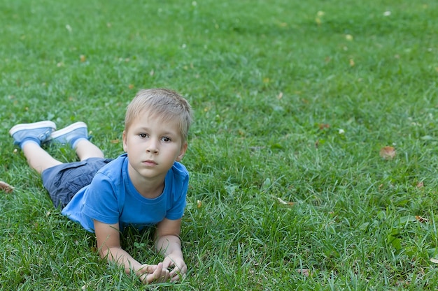 Niño lindo jugando en el parque verde