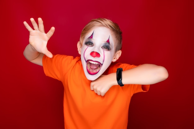 Niño con maquillaje para visualizar muestra los dientes y hace gestos amenazantes con las manos