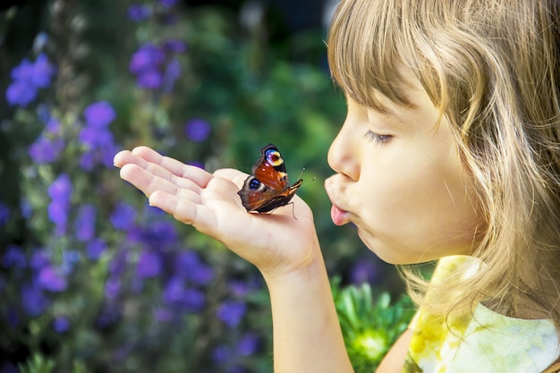 Niño con una mariposa en sus manos.