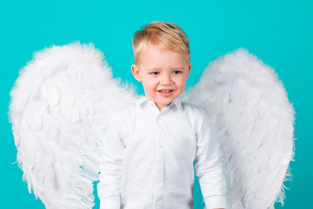 Niño niño con alas vestido como un ángel, aislado.